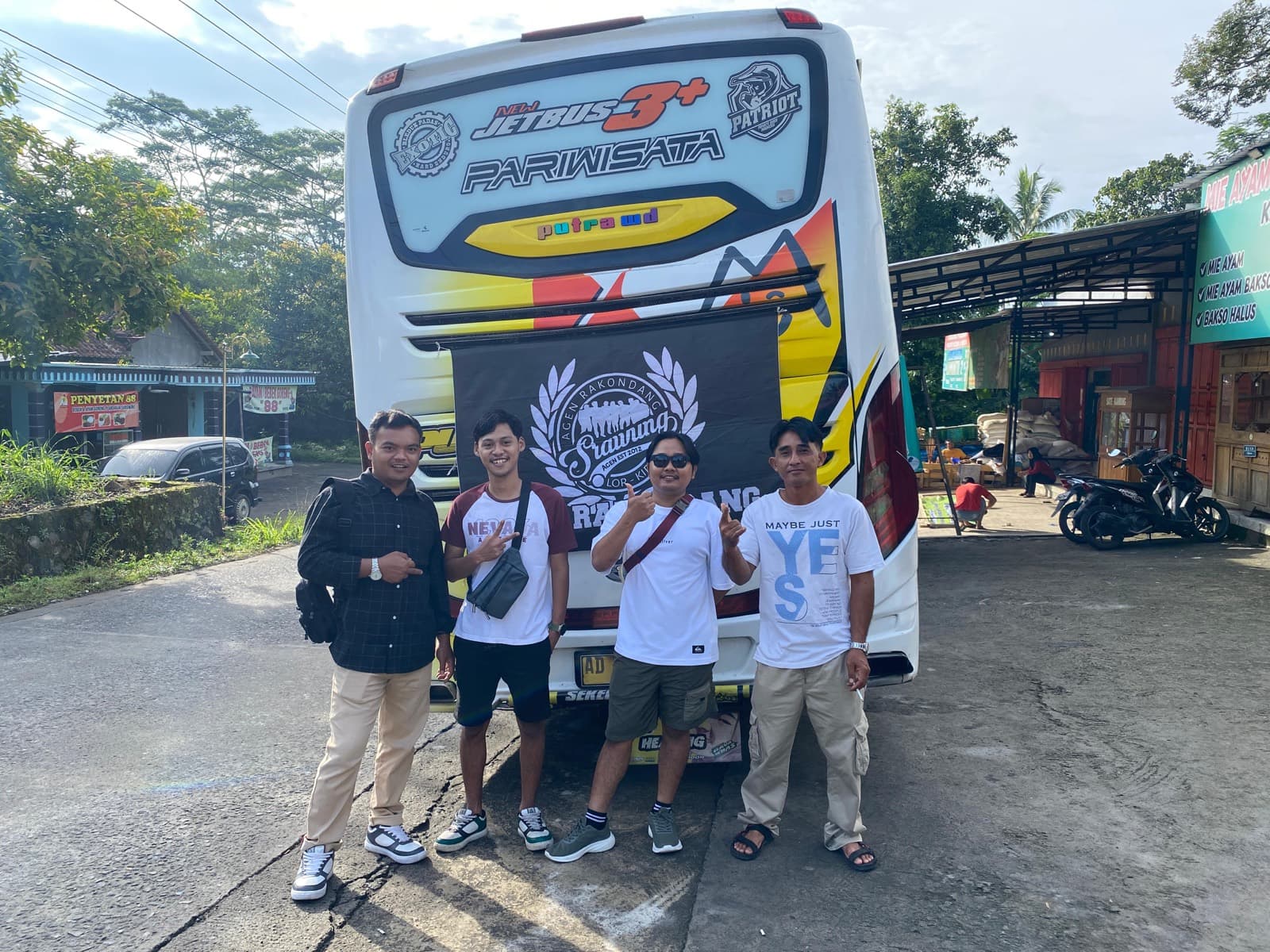 Anggota berpose santai di depan bus