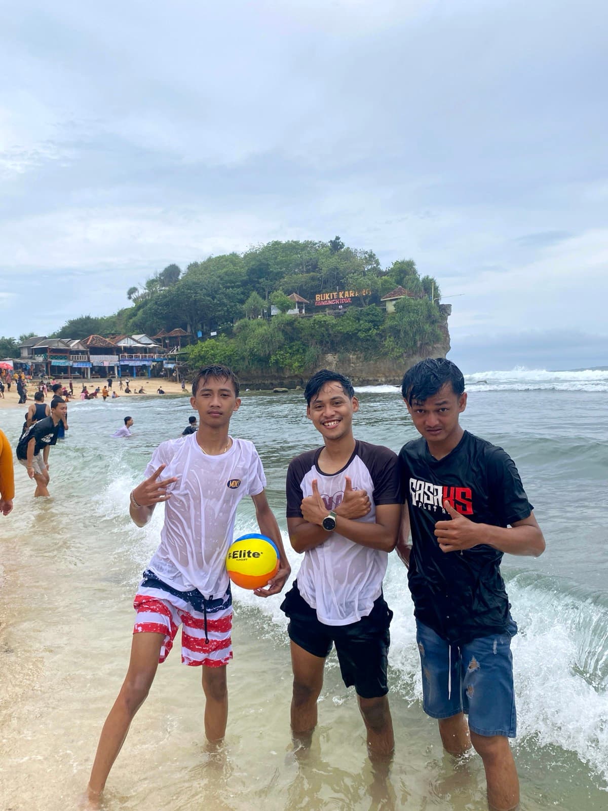 Tiga sahabat dengan bola voli pantai